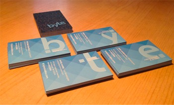 Image of business cards stacked in neat piles, showing off their designs